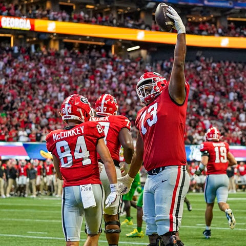 Georgia offensive lineman Xavier Truss (73) celebr