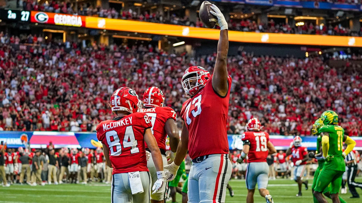 Georgia offensive lineman Xavier Truss (73) celebrates after wide receiver Ladd McConkey (84) scored a touchdown against Oregon during the first half at Mercedes-Benz Stadium.