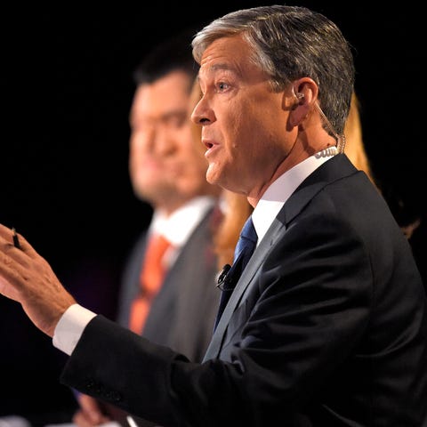 Debate moderator moderator John Harwood asks a que