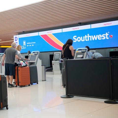 Traveler approaches the self-check-in kiosks for S