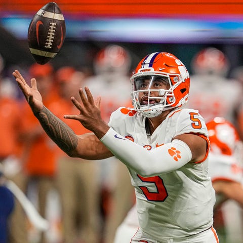 Clemson quarterback DJ Uiagalelei chases after a h