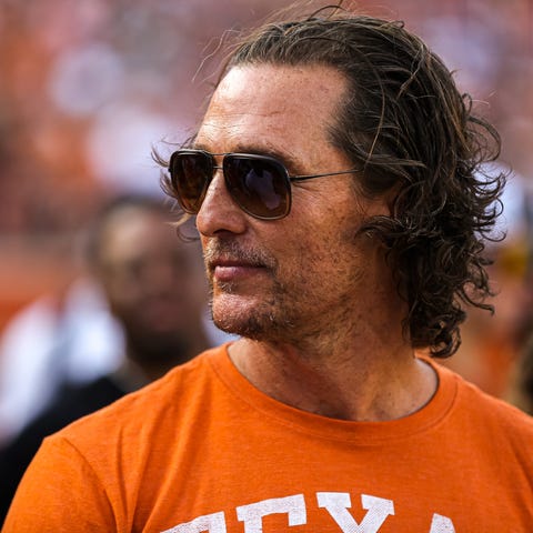 Matthew McConaughey stands on the sideline before 