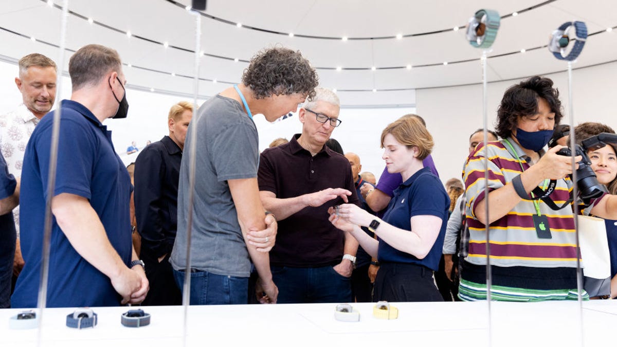 Apple CEO Tim Cook looks over one of the new Apple watches during a launch event for new products at Apple Park in Cupertino, California, on September 7, 2022.