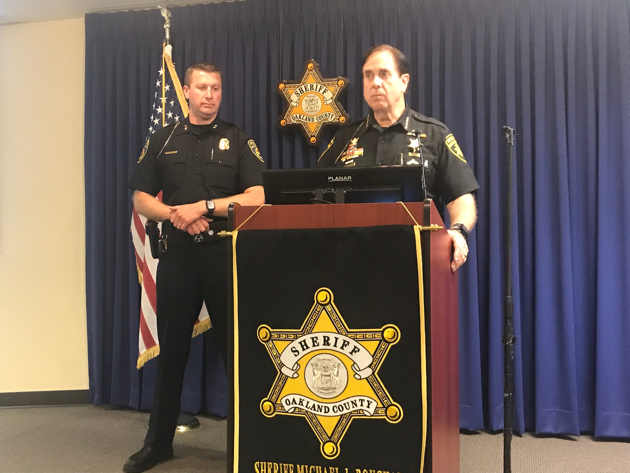 Oakland County Sheriff Michael Bouchard (right) and Walled Lake Police Chief Paul Shakinas speak about a homicide investigation that resulted in officers killing a man.