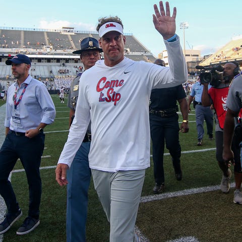 Mississippi coach Lane Kiffin waves to fans after 