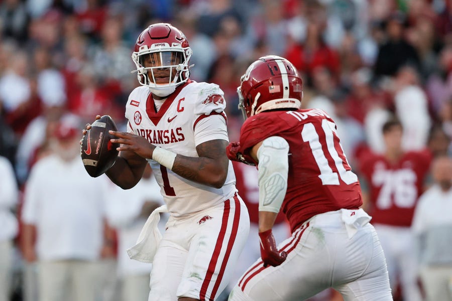 Arkansas quarterback KJ Jefferson (1) rolls out to pass as Alabama linebacker Henry To'oTo'o (10) applies pressure during the first half at Bryant-Denny Stadium.