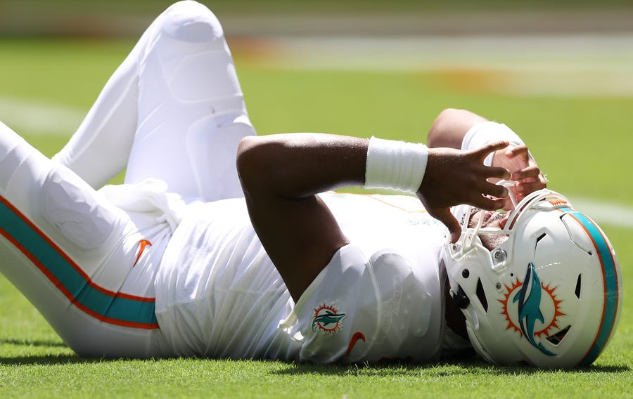 Dolphins QB Tua Tagovailoa lays on the turf after taking a hit in Week 3 against Buffalo.