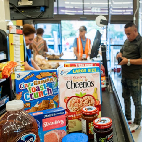 HOUSTON, TEXAS - JULY 15: A cashier processes a cu