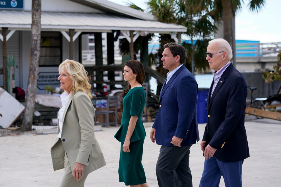 President Joe Biden, right, and first lady Jill Biden, left, tour an area impacted by Hurricane Ian with Florida Gov. Ron DeSantis, second from right, and his wife Casey DeSantis on Wednesday, Oct. 5, 2022, in Fort Myers Beach, Fla.