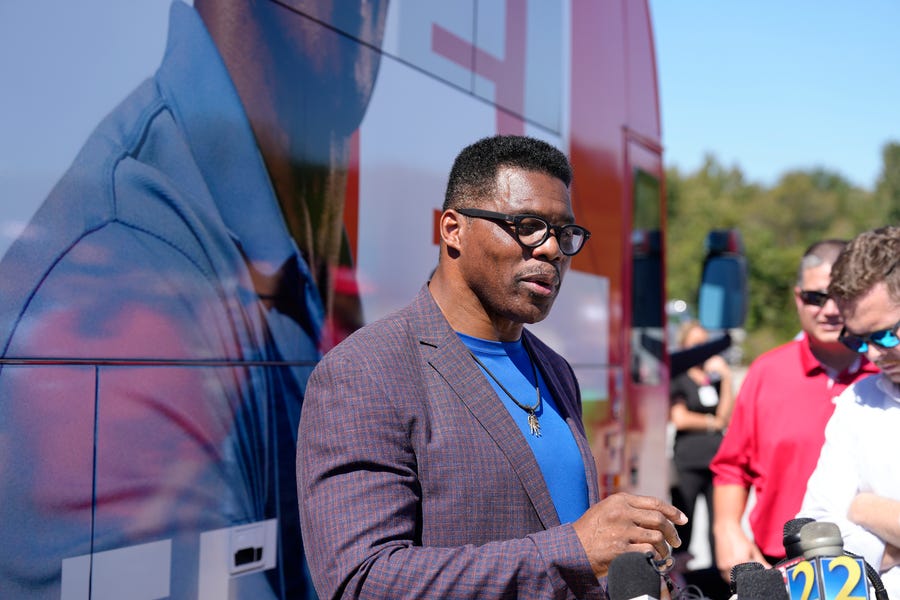 Georgia GOP Senate nominee Herschel Walker speaks with reporters following a campaign stop. Walker's appearance was his first following reports that a woman who said Walker paid for her 2009 abortion is actually mother of one of his children - undercutting Walker's claims he didn't know who she was .(AP Photo/Meg Kinnard)