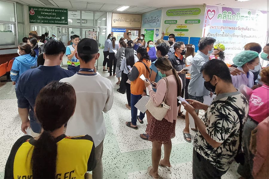 Residents line up to donate blood a the local hospital for victims of an attack at a daycare center, Thursday, Oct. 6, 2022, in the town of Nongbua Lamphu, north eastern Thailand. More than 30 people, primarily children, were killed Thursday when a gunman opened fire in the childcare center authorities said.