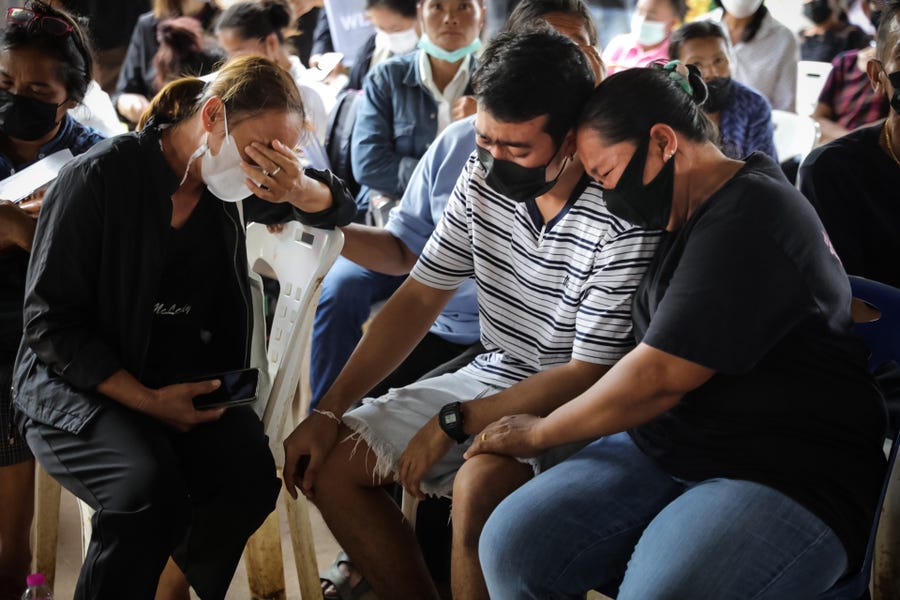 Families of victims mourn while waiting for blessings from Buddhist monks on October 07, 2022 in Uthai Sawan subdistrict, Nong Bua Lamphu, Thailand.