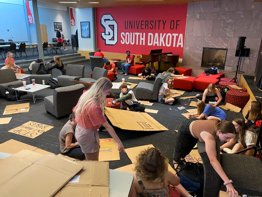 Preparing to march across the University of South Dakota's campus to protest the state's abortion ban, students made signs to communicate their feelings.