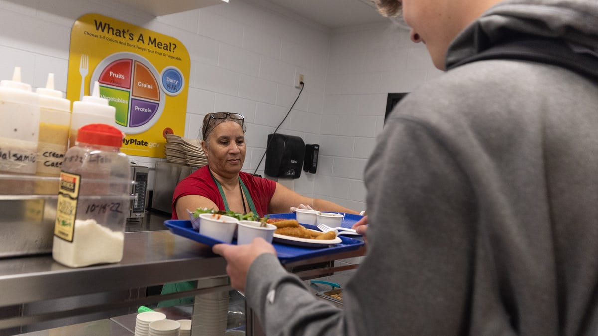 Cafeteria worker Denise Zavala serves students their lunch at Marlboro High School in Marlboro, NY on October 25, 2022.