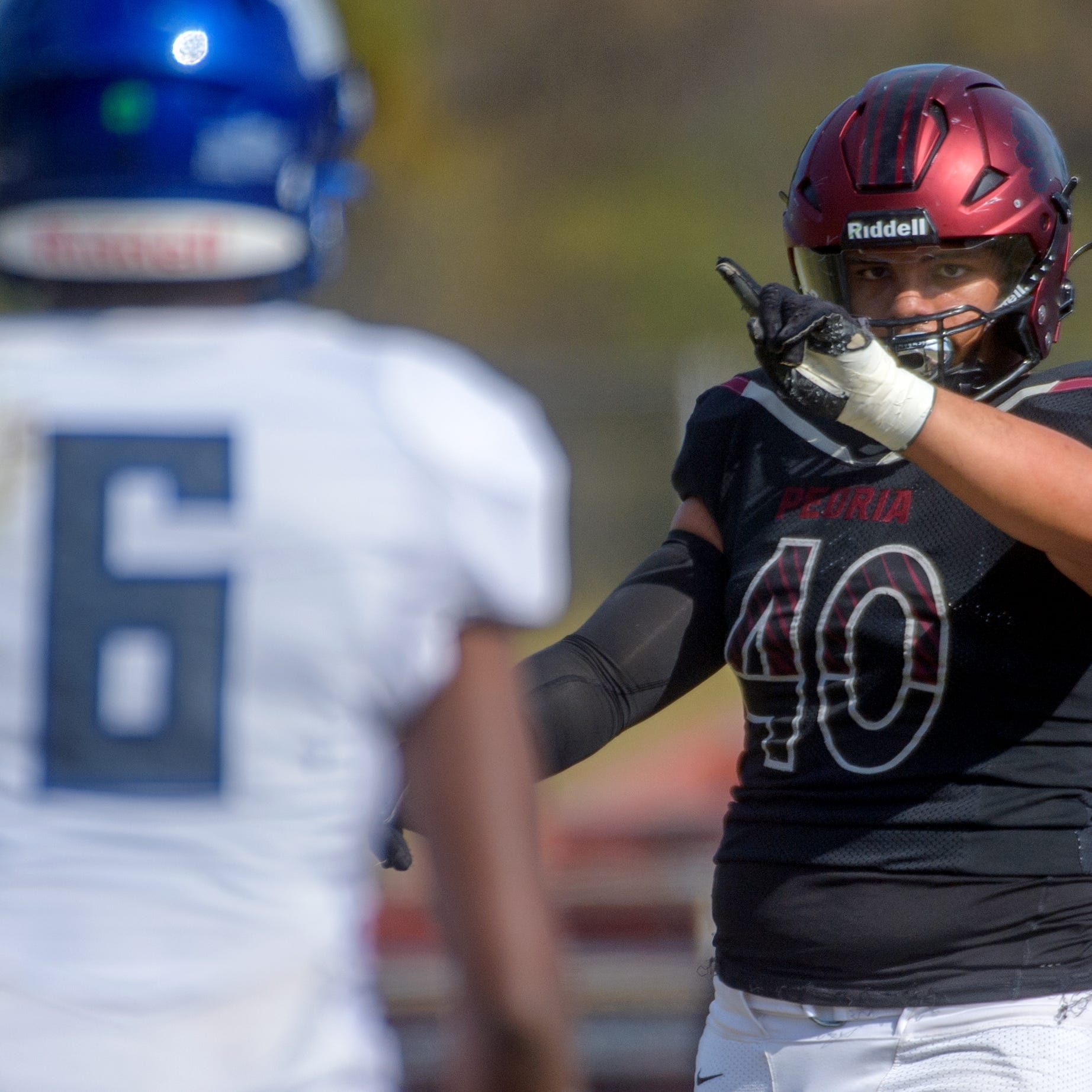 Peoria High's Landon Newby-Holesome wags his finger at Decatur MacArthur's Sam Owens after a play in the first half of their Class 5A first-round playoff game Saturday, Oct. 29, 2022 at Peoria Stadium. The Lions advanced with a 62-14 victory.