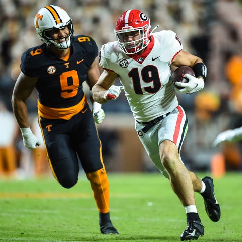 Georgia tight end Brock Bowers (19) runs away from