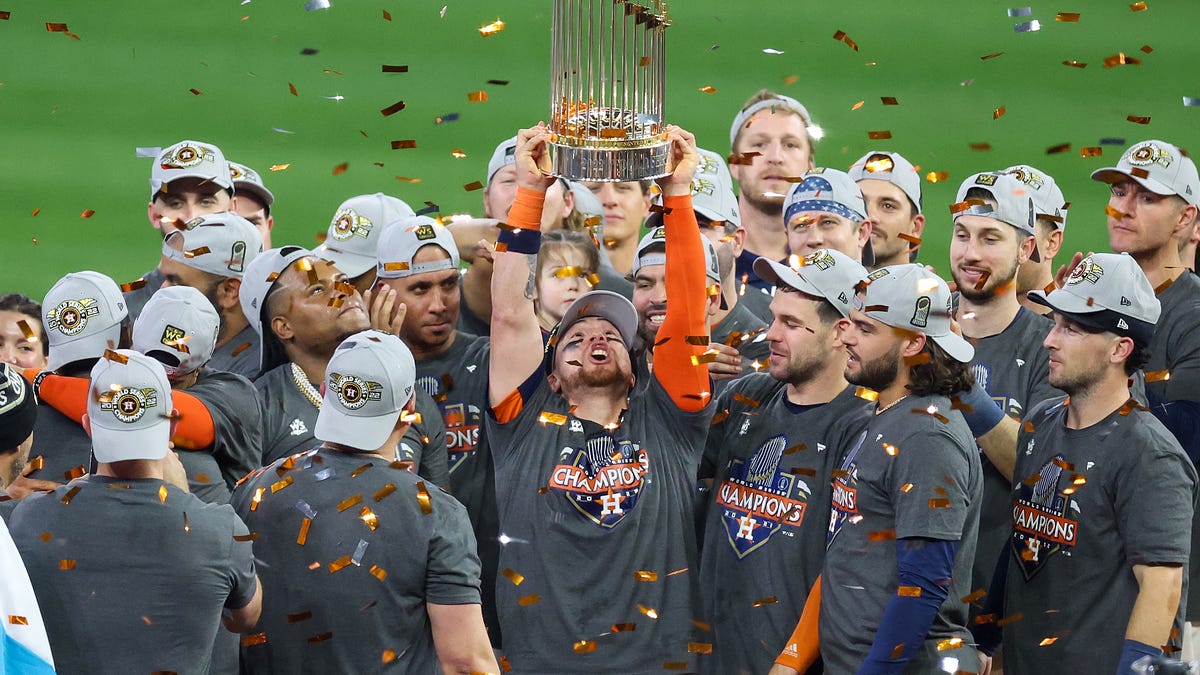 Astros players celebrate on the field after winning Game 6.