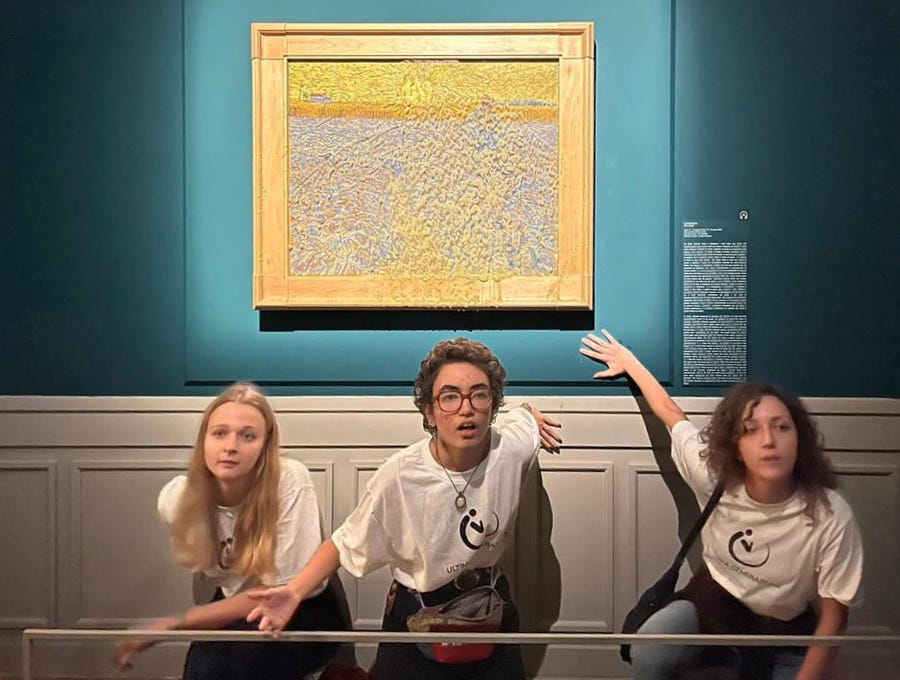 This photo obtained from Italian news agency Ansa on November 4, 2022 shows Climate activists from Last Generation posing by "The Sower", an 1888 painting by Dutch artist Vincent Van Gogh, after they threw pea soup at it on November 4, as it was on show at Rome's Palazzo Bonaparte.