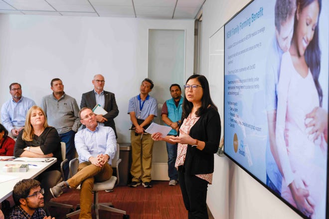 Lois Nafzger, right, leads a benefits meeting at AECOM's Dallas headquarters on November 2. (Shafkat Anowar/The Dallas Morning News/TNS)