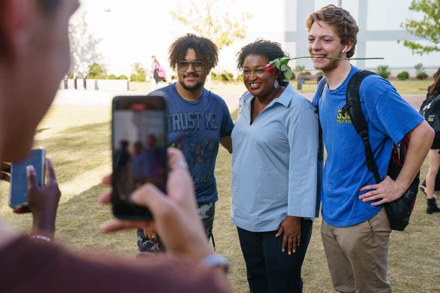 Democratic gubernatorial candidate Stacey Abrams poses for photos with students while encouraging voting at Georgia State University on November 7, 2022 in Atlanta, Georgia.