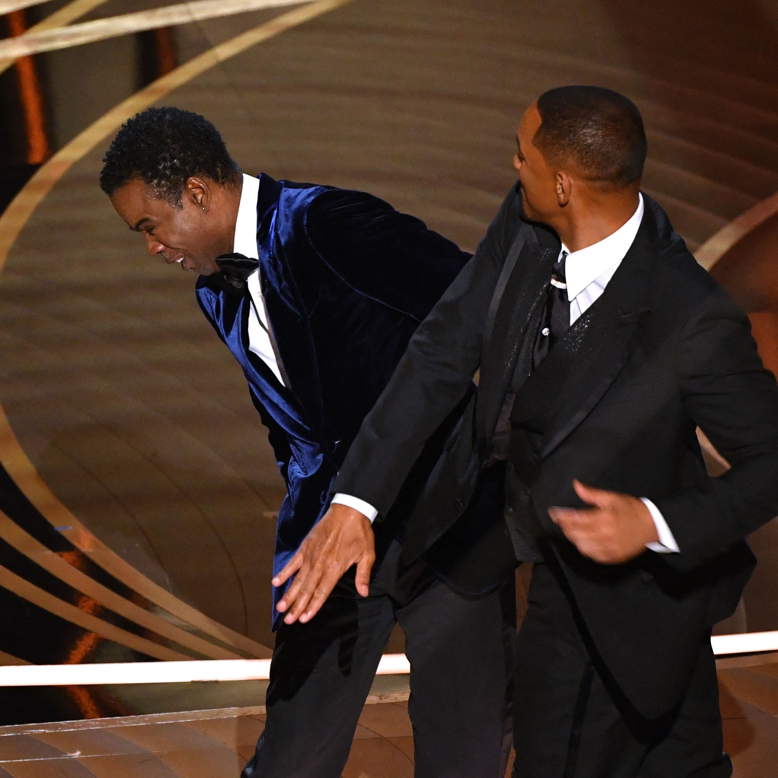 (FILES) In this file photo taken on March 27, 2022, US actor Will Smith (R) slaps US actor Chris Rock onstage during the 94th Oscars at the Dolby Theatre in Hollywood, California. - Less than a year after Will Smith shocked millions around the world by slapping Chris Rock at the Oscars, his new film "Emancipation" will be released this December, Apple said on October 3, 2022. (Photo by Robyn Beck / AFP) (Photo by ROBYN BECK/AFP via Getty Images) ORIG FILE ID: AFP_32KM9ZK.jpg