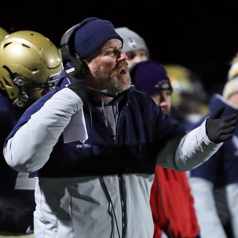 Hoban football coach Tim Tyrrell works the sidelin