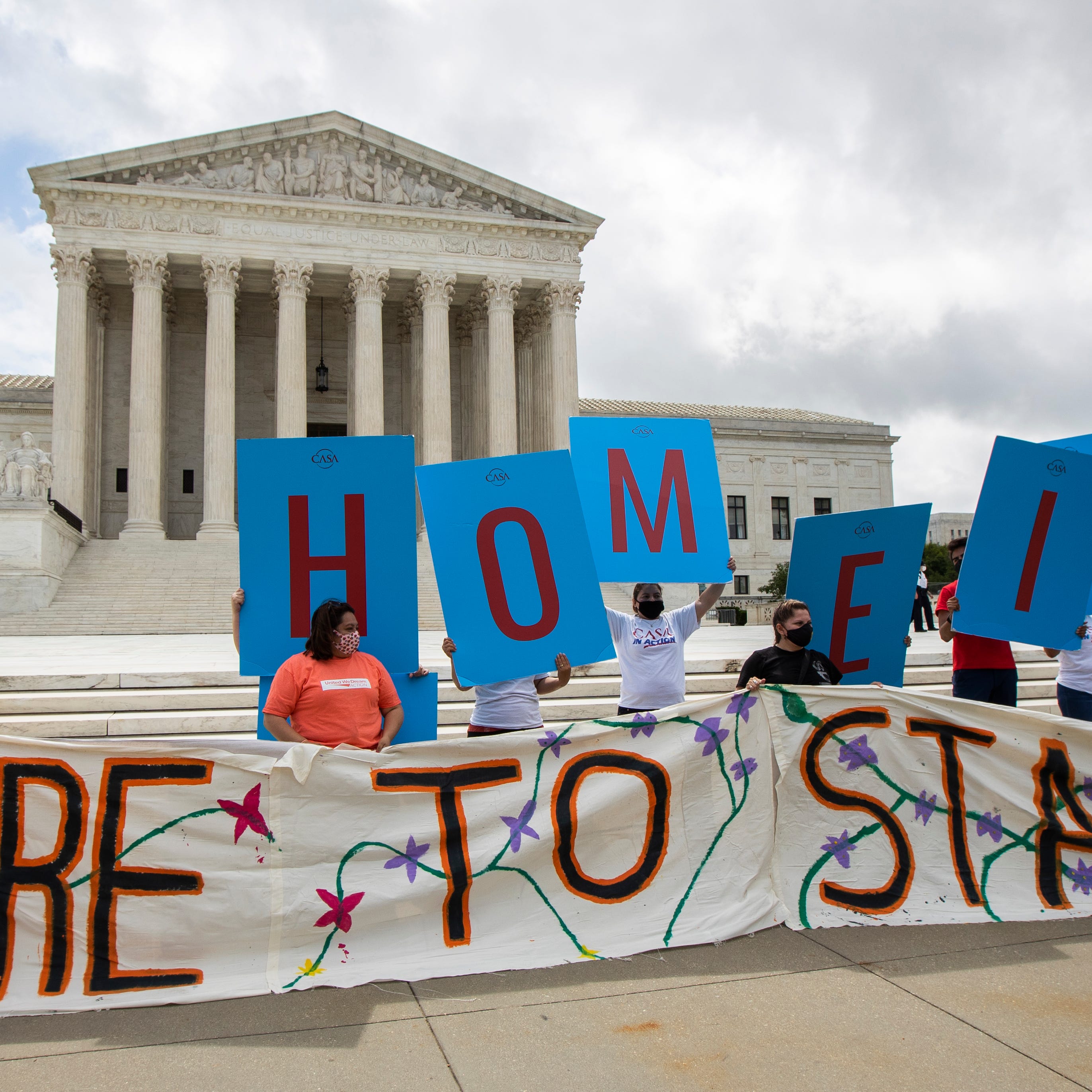 Deferred Action for Childhood Arrivals (DACA) recipient Roberto Martinez, left, celebrates with other DACA recipients in front of the Supreme Court on Thursday, June 18, 2020, in Washington. The Supreme Court on Thursday rejected President Donald Trump's effort to end legal protections for 650,000 young immigrants, a stunning rebuke to the president in the midst of his reelection campaign. (AP Photo/Manuel Balce Ceneta) ORG XMIT: DCMC105