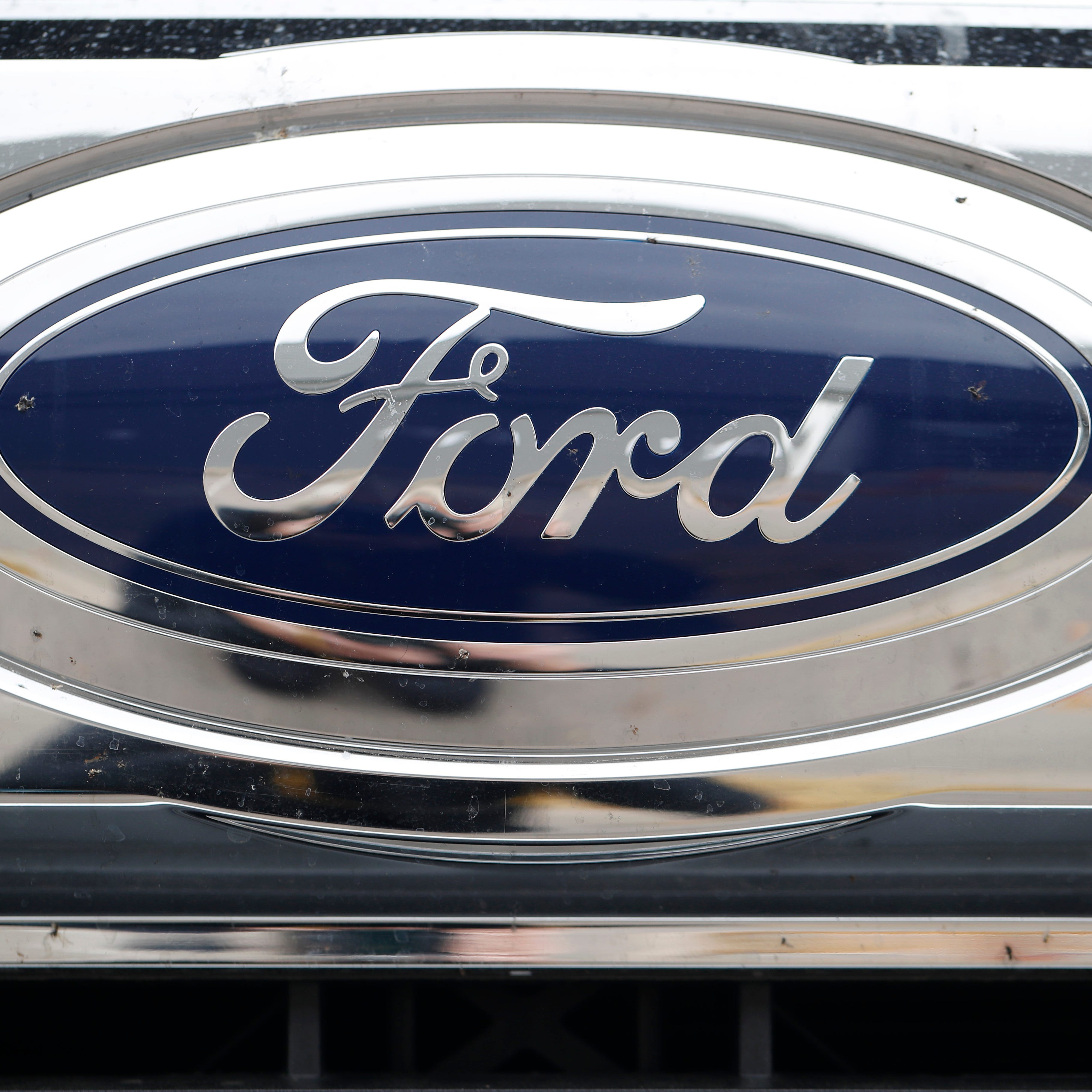 FILE - In this Oct. 20, 2019 file photograph, the company logo shines off the grille of an unsold vehicle at a Ford dealership in Littleton, Colo. Ford is recalling over 634,000 SUVs worldwide, Thursday, Nov. 24, 2022, because a cracked fuel injector can spill fuel or leak vapors onto a hot engine and cause fires. The recall covers Bronco Sport and Escape SUVs from the 2020 through 2023 model years with 1.5-liter, three-cylinder engines.  (AP Photo/David Zalubowski, File)