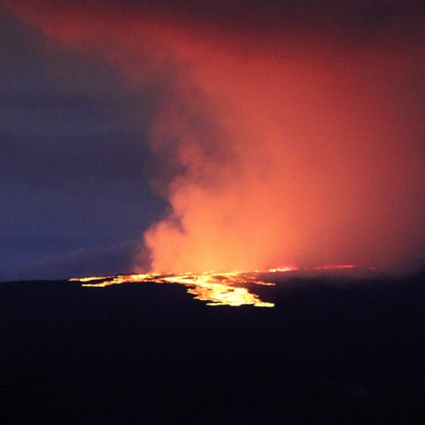 Lava pours out of the summit crater of Mauna Loa a