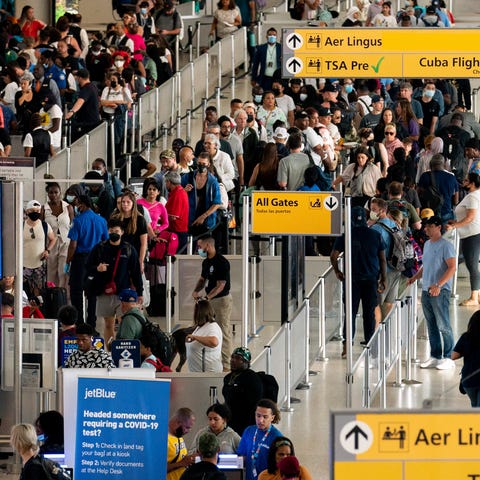 People wait in a TSA line at the John F. Kennedy I