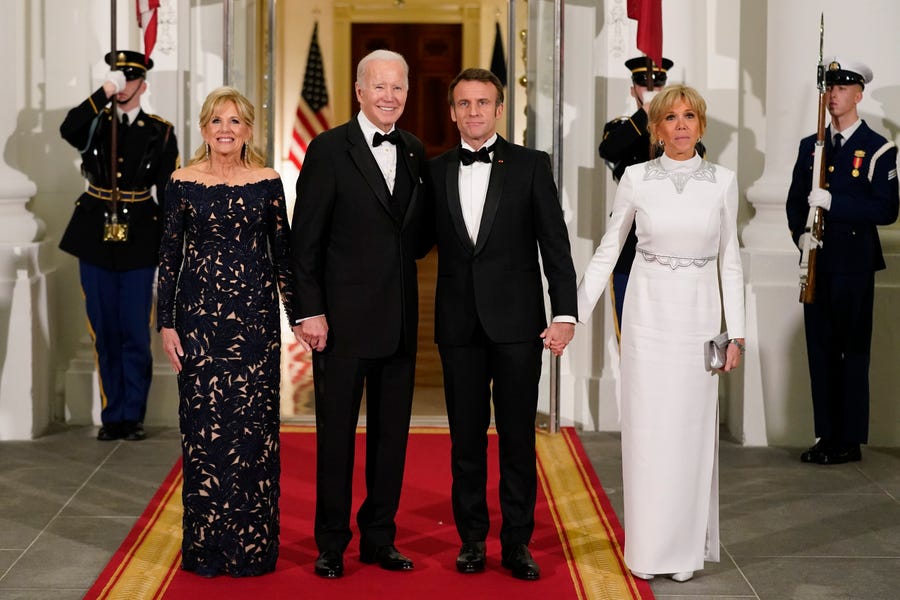 President Joe Biden and first lady Jill Biden pose for photos with French President Emmanuel Macron and his wife Brigitte Macron as they arrive for a state dinner in Washington Dec. 1.