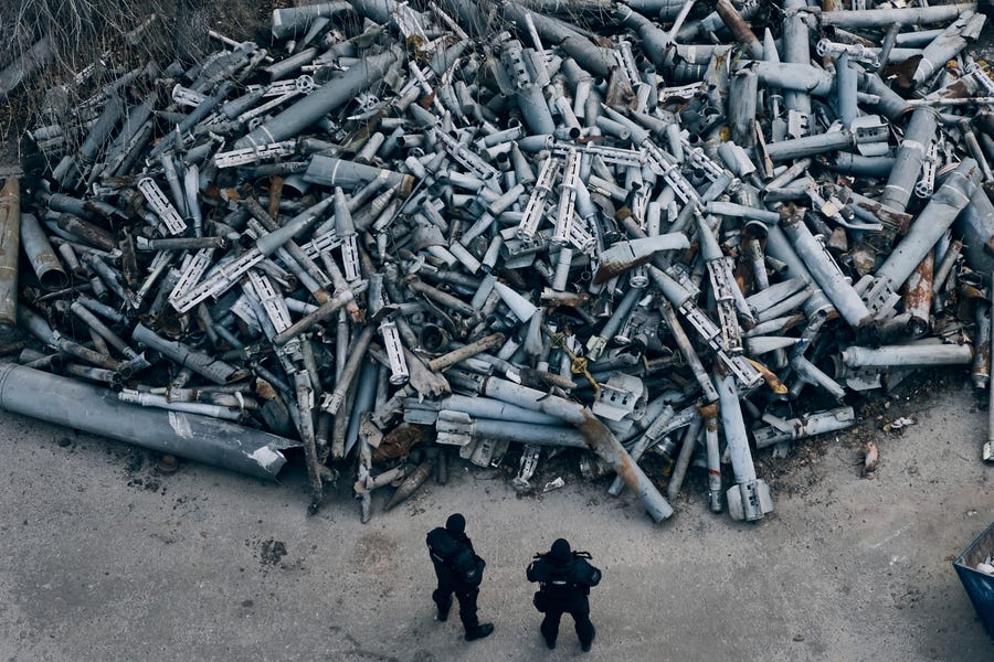 Police officers look at collected fragments of the Russian rockets that hit Kharkiv, in Kharkiv, Ukraine, Saturday, Dec. 3, 2022.