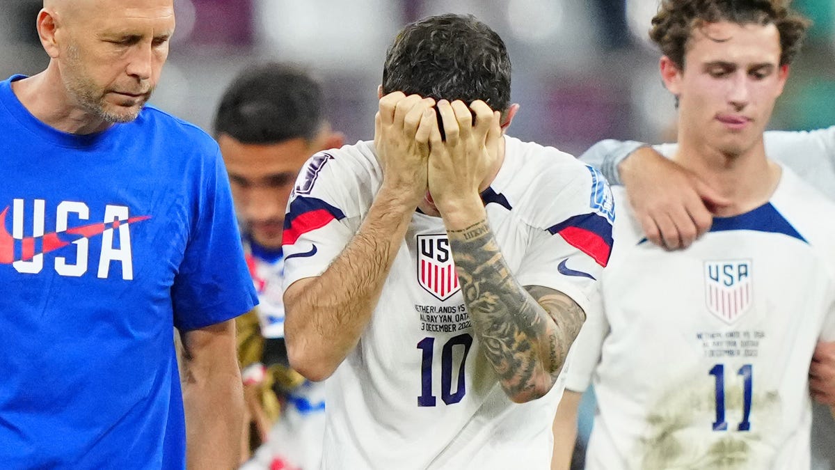 American coach Gregg Berhalter and Christian Pulisic react after the loss to the Netherlands.