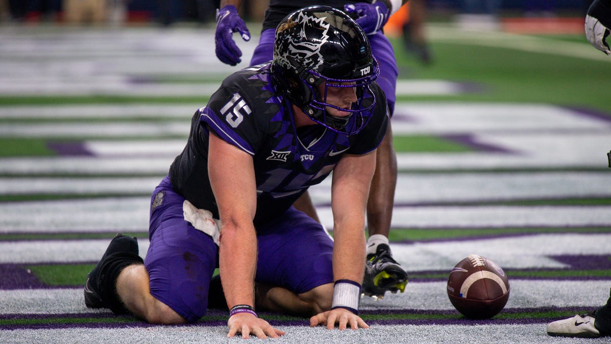 TCU quarterback Max Duggan (15) kneels on the field after scoring a touchdown against Kansas State during the second half of the 2022 Big 12 title game at AT&T Stadium.