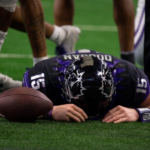 TCU quarterback Max Duggan lies on the field after