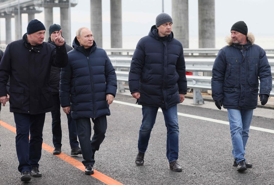 Russian President Vladimir Putin, flanked by Deputy Prime Minister Marat Khusnullin (L), visits the Kerch Strait Bridge, also known as the Crimean Bridge on December 5, 2022.