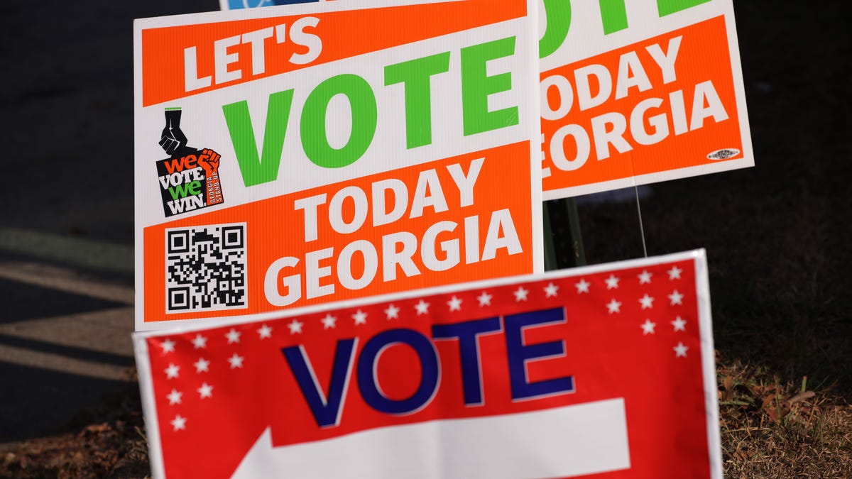 Signs that encourage people to vote are seen outside a polling station on November 29, 2022 in Atlanta, Georgia.