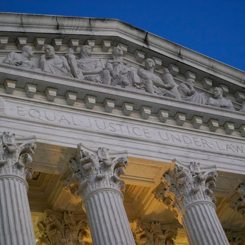 FILE - Light illuminates part of the Supreme Court