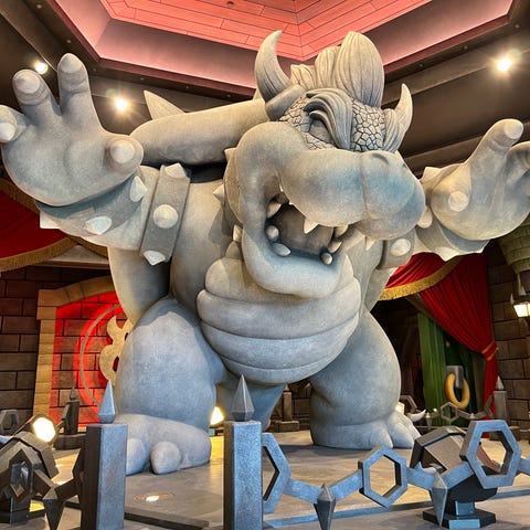 A giant Bowser statue greets riders of Mario Kart 