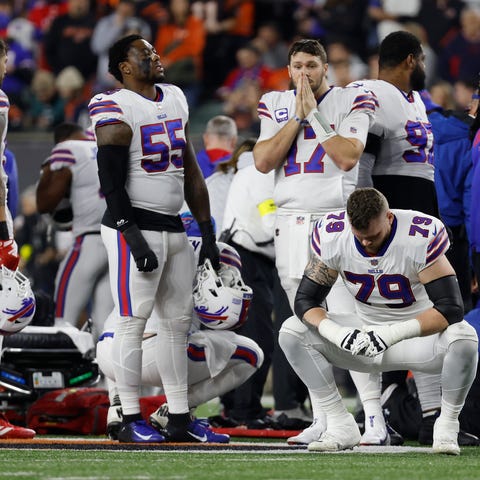 Buffalo Bills players react after teammate Damar H