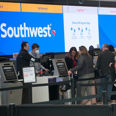 Travelers queue up at the check-in counters for So