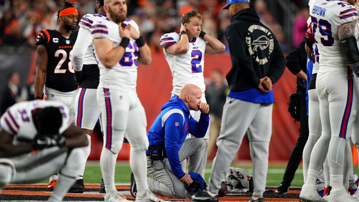 Buffalo Bills head coach Sean McDermott takes a knee  as Damar Hamlin is tended to on the field following a collision against the Cincinnati Bengals.