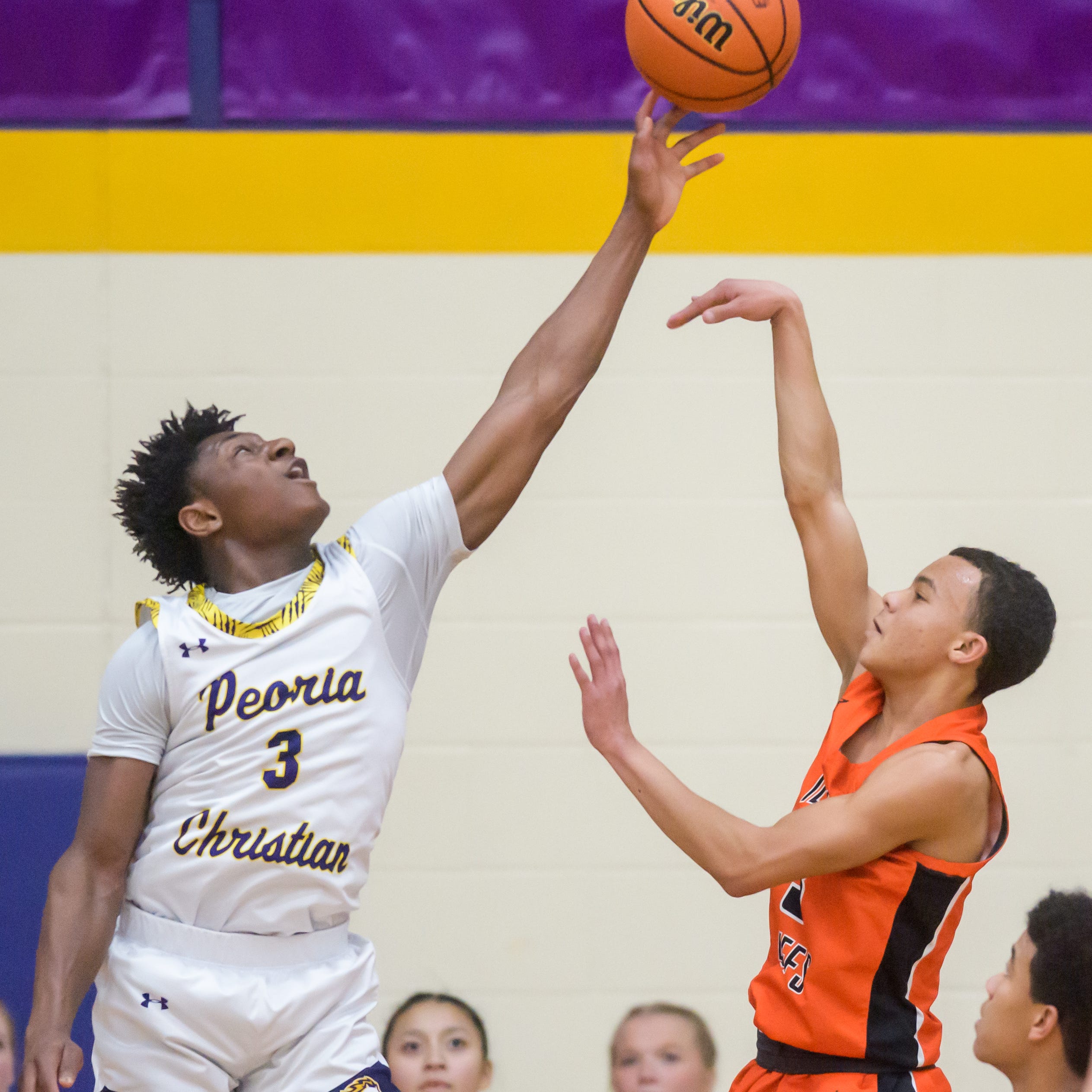 Peoria Christian's Keton Isuwami (3) blocks a shot from Illini Bluffs' Jayden Washington in the second half Friday, Jan. 20, 2023 at Peoria Christian High School. The Tigers defeated the Crusaders 45-35.