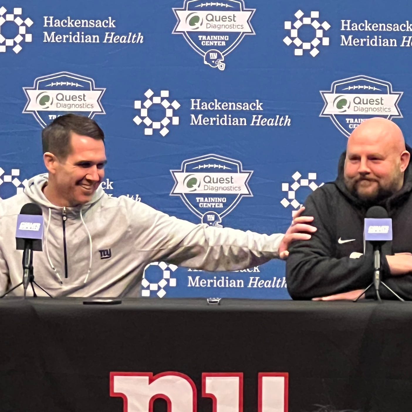 Giants general manager Joe Schoen jokes with head coach Brian Daboll during Monday's end-of-season joint news conference.