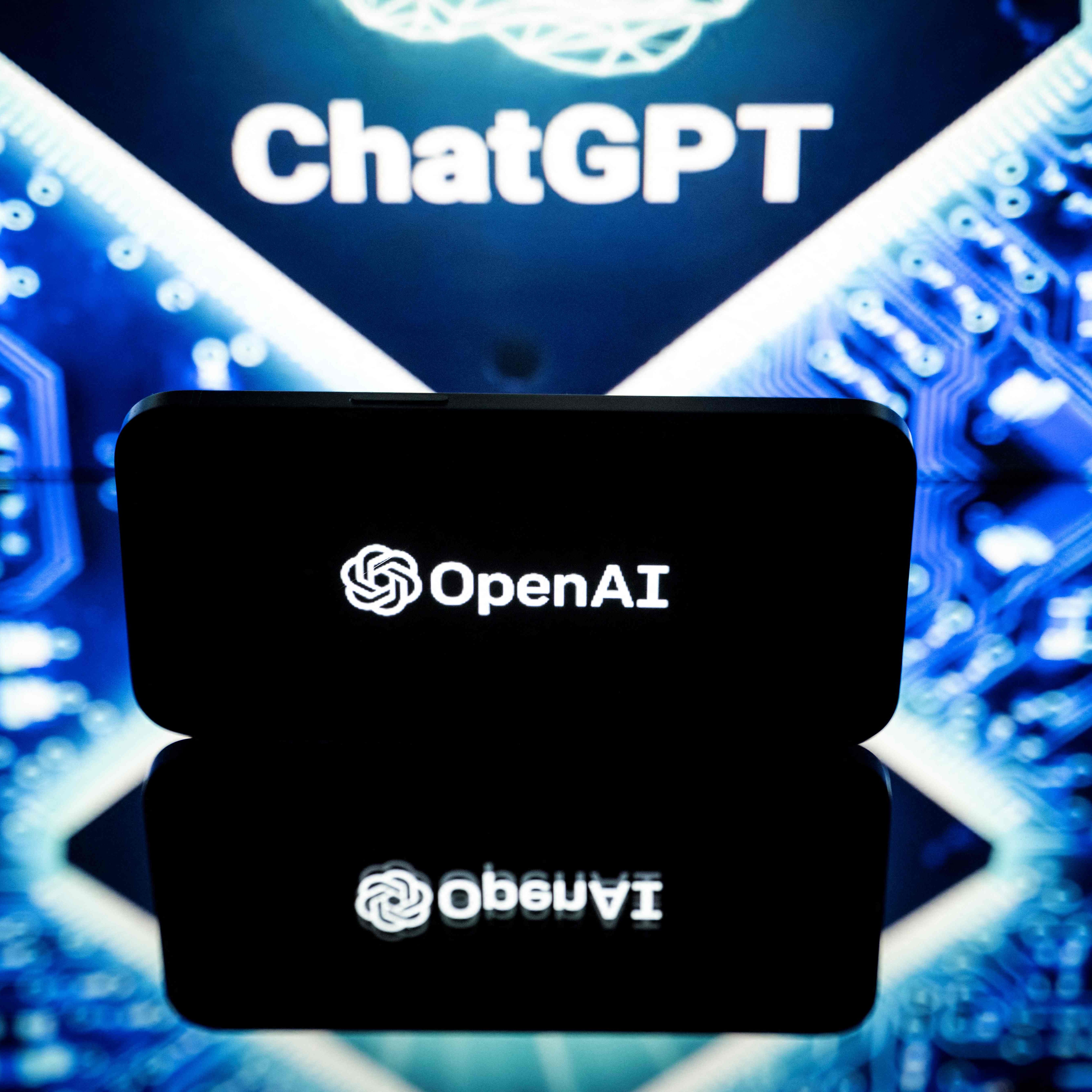 This picture taken on January 23, 2023 in Toulouse, southwestern France, shows screens displaying the logos of OpenAI and ChatGPT. - ChatGPT is a conversational artificial intelligence software application developed by OpenAI.