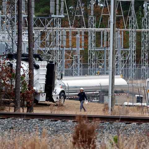 Workers work on equipment at the West End Substati