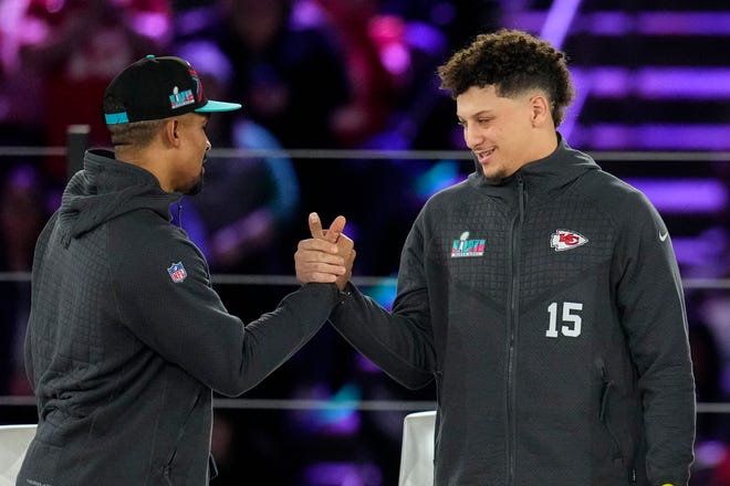 Philadelphia Eagles quarterback Jalen Hurts, left, and Kansas City Chiefs quarterback Patrick Mahomes shake hands during the NFL football Super Bowl 57 opening night, Monday, Feb. 6, 2023, in Phoenix. The Kansas City Chiefs will play the Philadelphia Eagles on Sunday. (AP Photo/Ross D. Franklin)