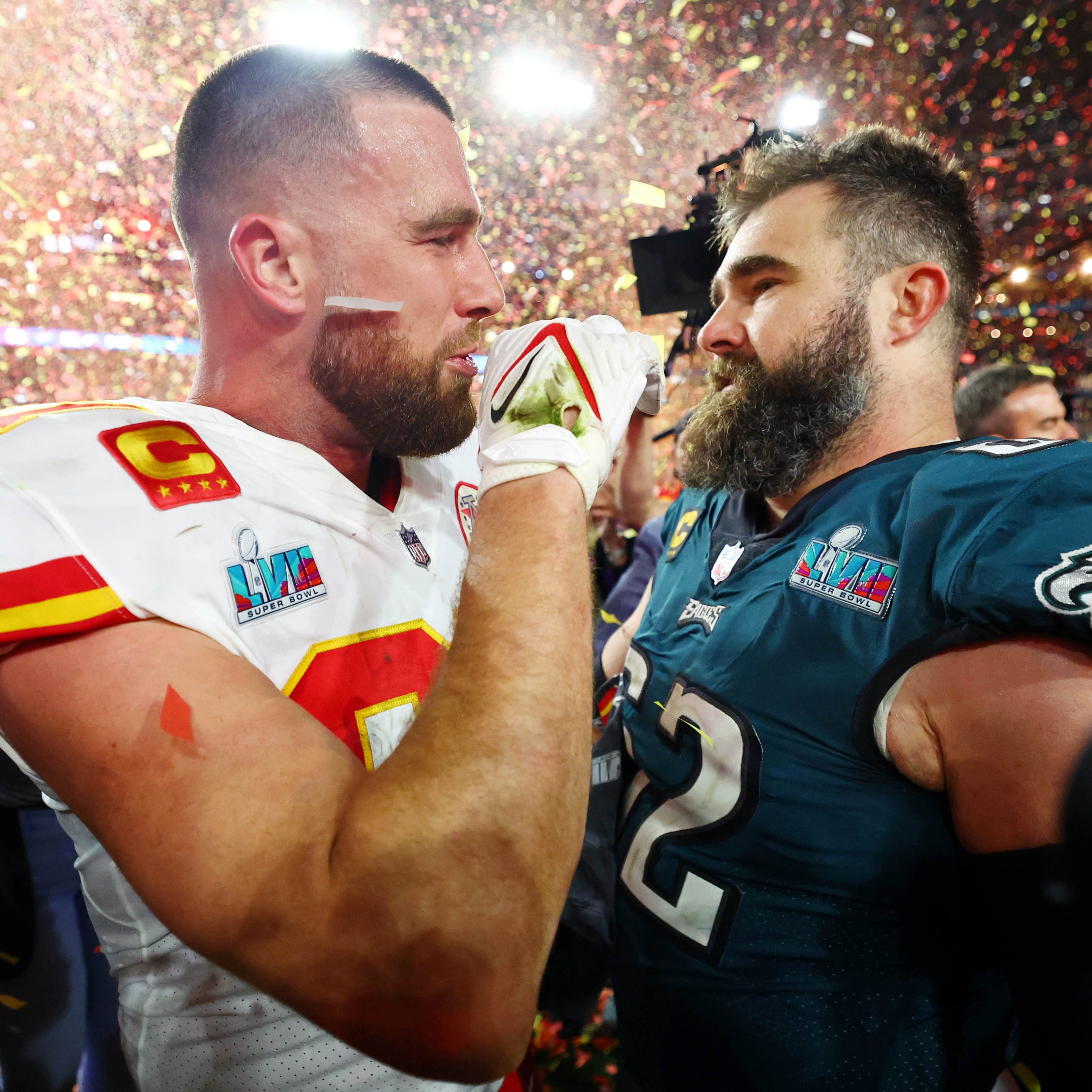 Kansas City Chiefs tight end Travis Kelce (87) talks with his brother, Philadelphia Eagles center Jason Kelce (62), after the Super Bowl.