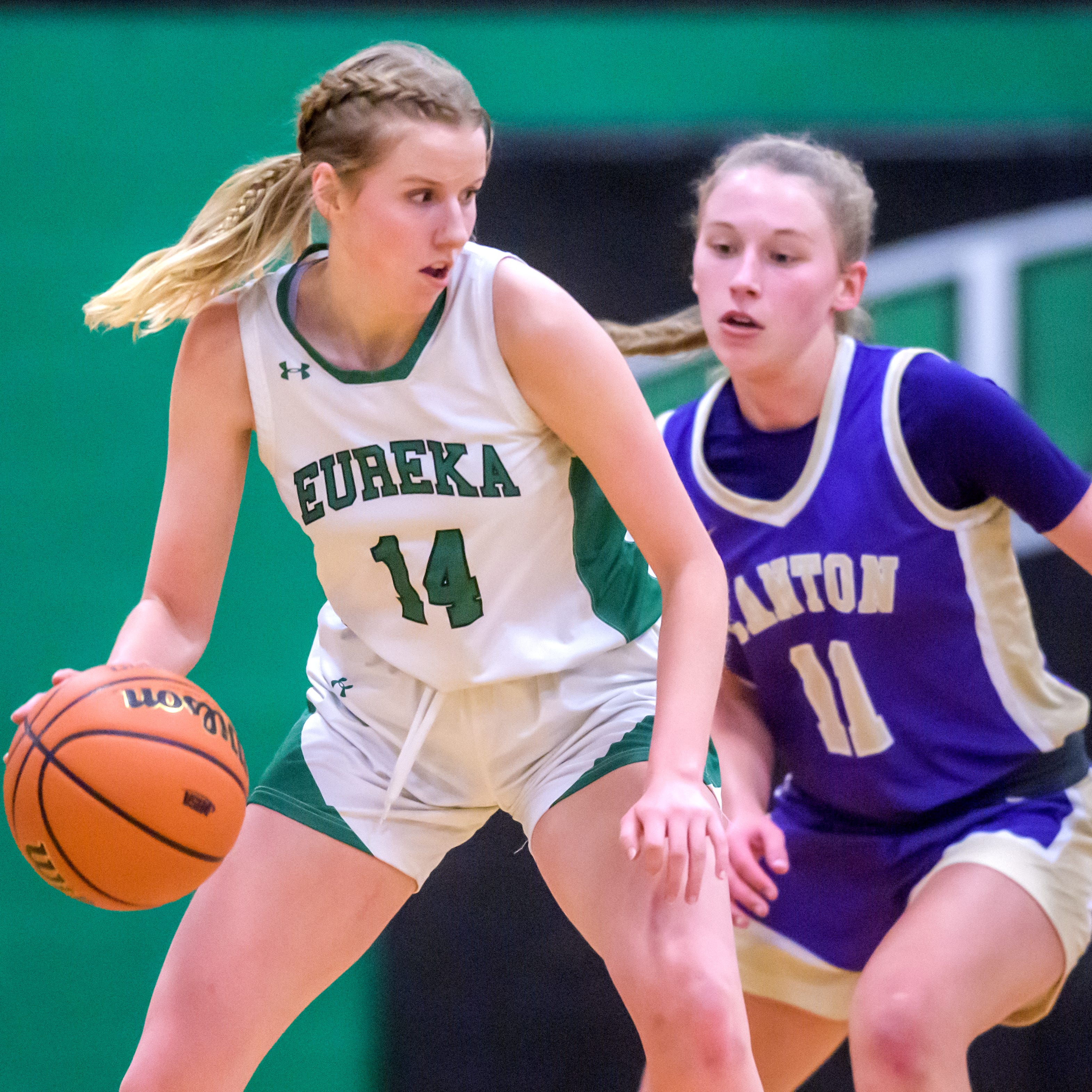 Eureka's Ellie Cahill (14) tries to move the ball around Canton's Ella Demler in the first half of the Class 2A Girls Basketball Eureka Regional title game Friday, Feb. 17, 2023 in Eureka. The Hornets defeated the Little Giants 61-55 in overtime.