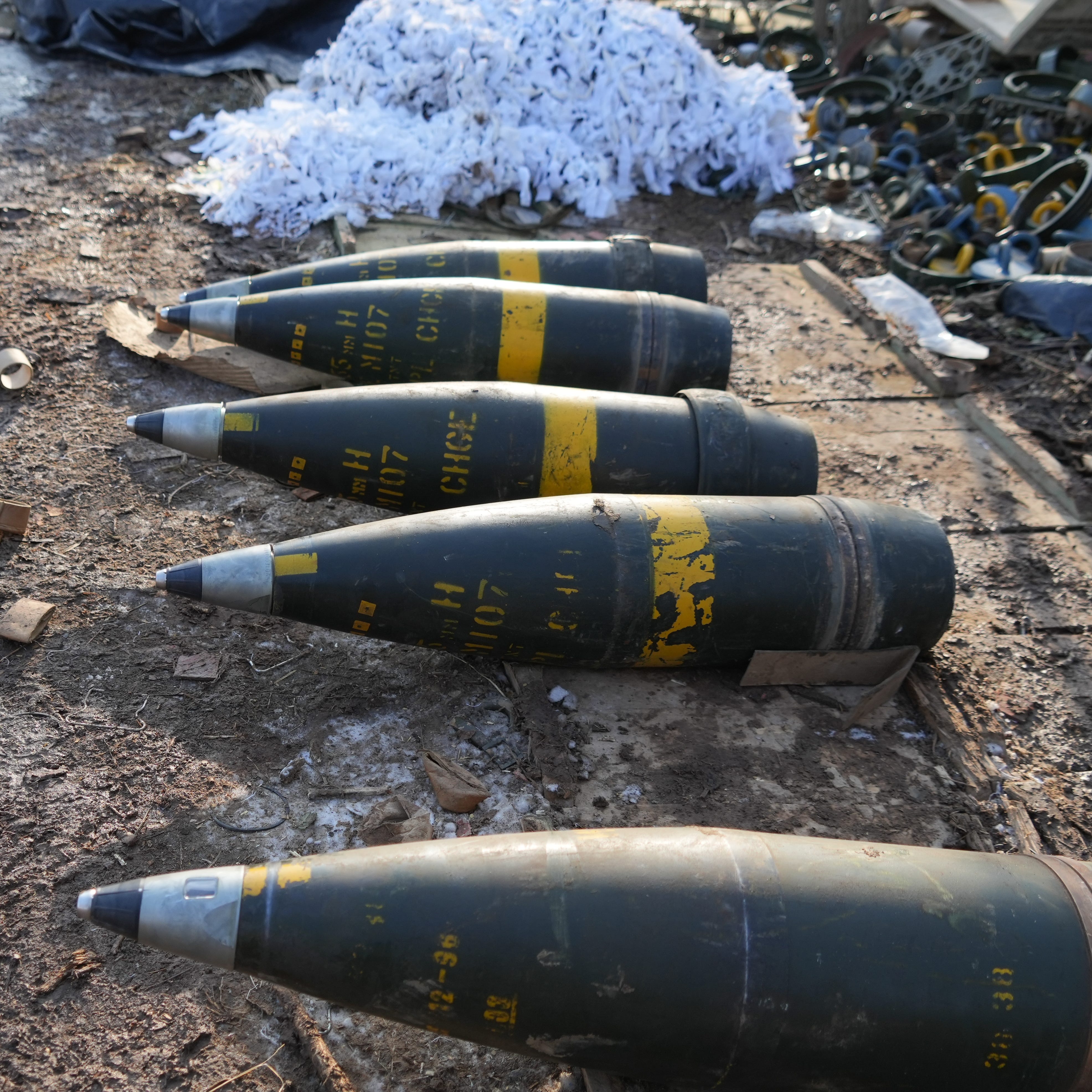 GPS-guided shells used by an American-made M777 howitzer are seen on the ground near the artillery weapon near a frontline position held by Ukraine's military on Feb. 11, 2023.